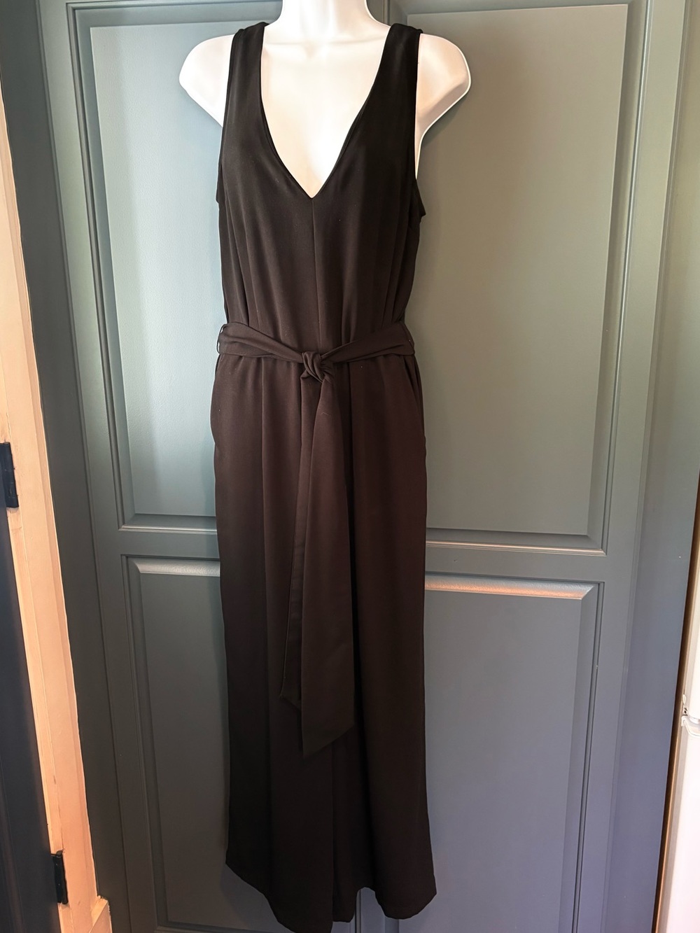 A New Day black sleeveless jumpsuit with  pockets and a self-tie waist belt.